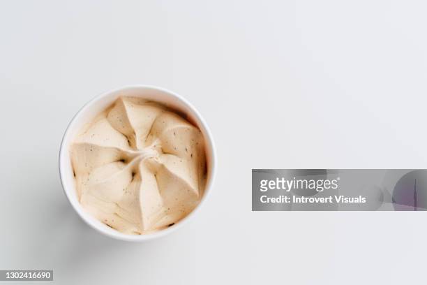 beige salted caramel ice cream in a jar on white background with copy space - ice cream cup stock-fotos und bilder