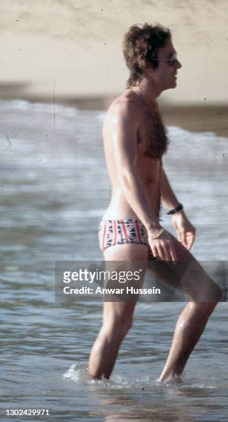Roddy Llewellyn, Princess Margaret's boyfriend, goes a swim in the sea wearing Union Jack swimming trunks while on holiday in the island of Mustique...