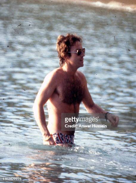 Roddy Llewellyn, Princess Margaret's boyfriend, goes a swim in the sea wearing Union Jack swimming trunks while on holiday in the island of Mustique...