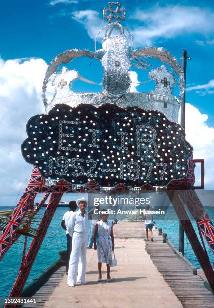 Princess Margaret and Colin Tennant, Lord Glenconner wait on the jetty for Queen Elizabeth ll and Prince Philip's arrival to Mustique on Britannia in...