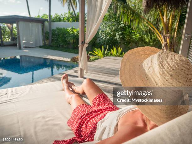 woman relaxing in private pool villa - poolside stock pictures, royalty-free photos & images
