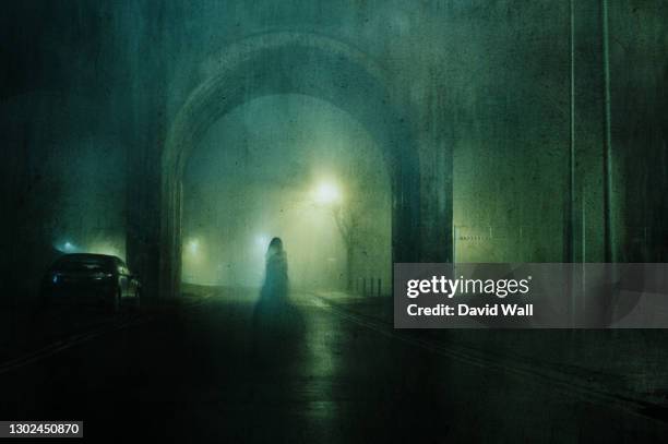 a ghostly transparent woman. standing underneath an arch of a bridge. on an atmospheric winters night in town. with a grunge, blurred vintage edit. - ghost stock pictures, royalty-free photos & images