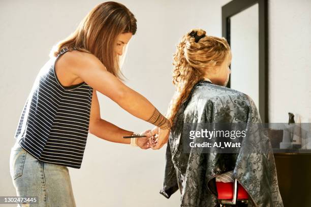 girl getting a haircut at salon - cutting hair stock pictures, royalty-free photos & images