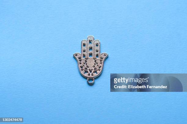 'hamsa', the hand for good luck or the hand of fatima, on blue background - hand of fatima stock pictures, royalty-free photos & images
