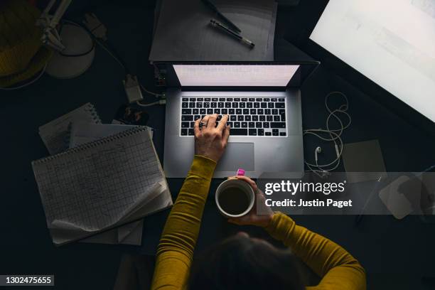 overhead view of woman working from home - woman adult hand stock-fotos und bilder