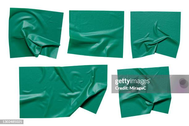 pieces of green colored plastic adhesive tape - stickers stockfoto's en -beelden