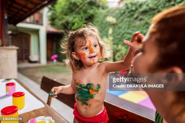fun time of mother and daughter painting together - brazil body paint stock pictures, royalty-free photos & images