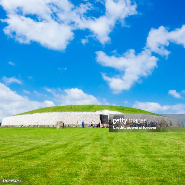 tourists at newgrange in county meath, ireland. - newgrange stock pictures, royalty-free photos & images