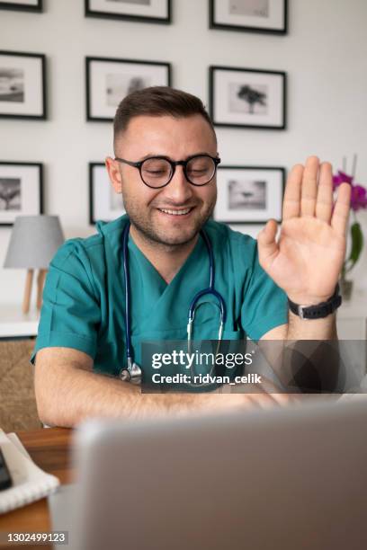 headshot portrait young doctor speaking, consulting online - general view stock pictures, royalty-free photos & images