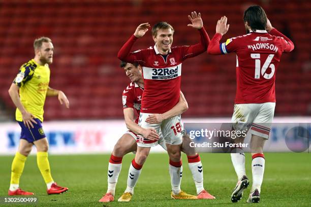 Duncan Watmore of Middlesbrough celebrates with team mates Paddy McNair and Jonny Howson after scoring their side's first goal during the Sky Bet...