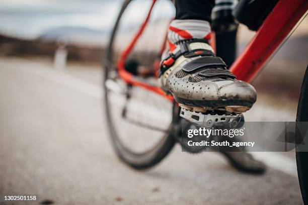 male cyclist foot on bicycle pedal - bike pedal stock pictures, royalty-free photos & images