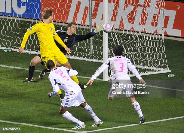 William Hesmer of the Columbus Crew makes a save on the Cory Gibbs of the Chicago Fire and Dan Gargan during an MLS match on October 22, 2011 at...