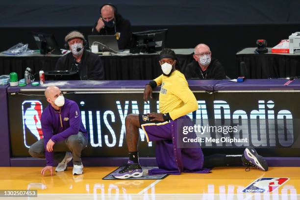Montrezl Harrell of the Los Angeles Lakers stretches on the sideline during the game against the Memphis Grizzlies at Staples Center on February 12,...