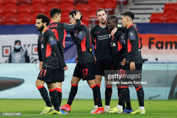 Sadio Mane of Liverpool celebrates with team mates Jordan Henderson and Roberto Firmino after scoring their side's second goal during the UEFA...