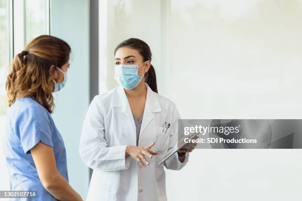 essential healthcare workers - nurse mask stock pictures, royalty-free photos & images