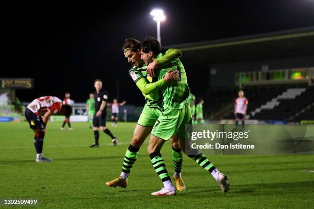 Josh Davison of Forest Green Rovers celebrates with team-mate Isaac Hutchinson after scoring his team's fourth goal during the Sky Bet League Two...