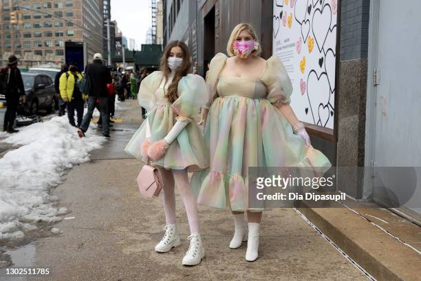 Mother Michelle Blashka and daughter Ella Sophie Blashka wearing matching pastel colored dresses pose outside New York Fashion Week at Spring Studios...