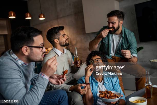 friends at home eating fast food - chicken wings stock pictures, royalty-free photos & images