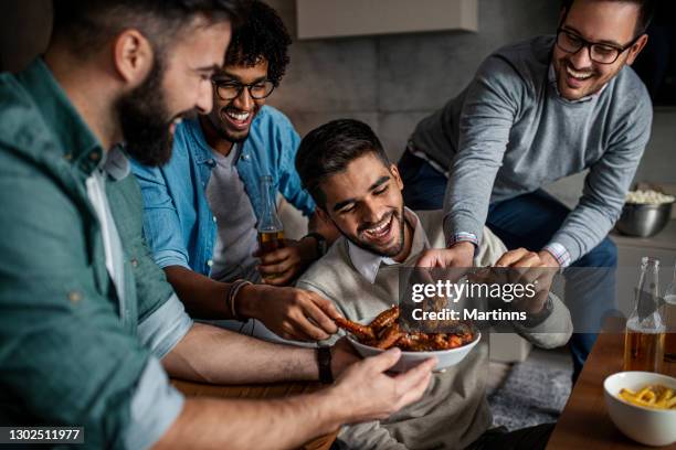 friends at home eating fast food - chicken wings stock pictures, royalty-free photos & images