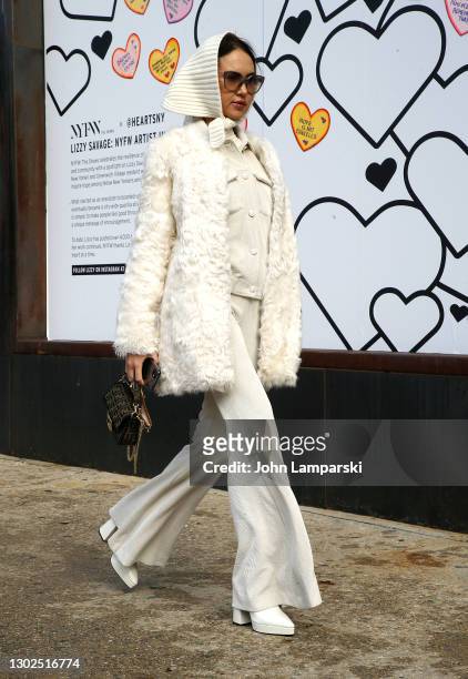 Guest wearing a DVI coat, MVP Wardrobe suit, hat by Rafaello Bettina and bag by Fendi during New York Fashion Week at Spring Studios on February 16,...