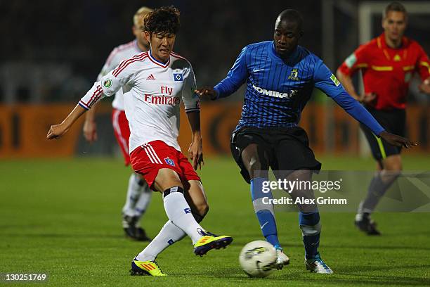 Heung-Min Son of Hamburg is challenged by Jerry Opoku-Karikari of Trier during the DFB Cup second round match between Eintracht Trier and Hamburger...