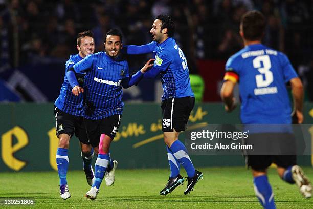 Ahmet Kulabas of Trier celebrates his team's first goal with team mates during the DFB Cup second round match between Eintracht Trier and Hamburger...
