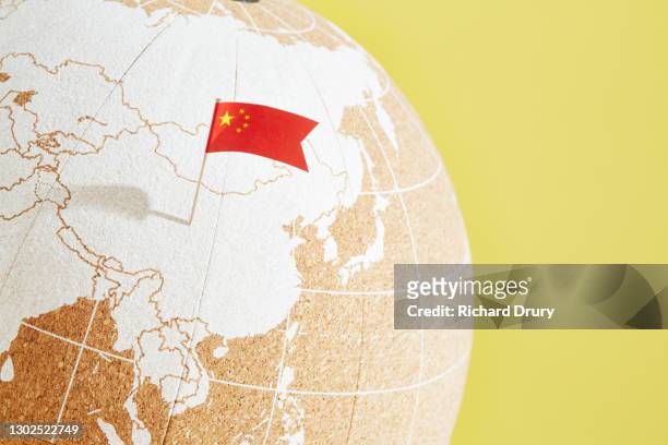 a world globe with a chinese flag pin showing china - 中国の国旗 ストックフォトと画像