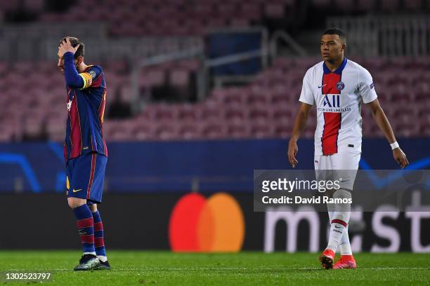 Lionel Messi of FC Barcelona shows his dejection next to Kylian Mbappe of Paris Saint-Germain during the UEFA Champions League Round of 16 match...