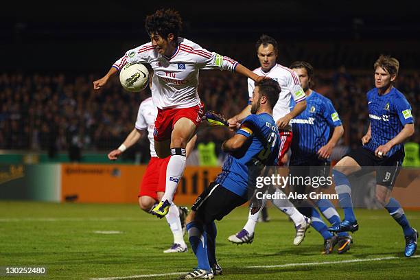 Heung-Min Son of Hamburg is challenged by Denny Herzig of Trier during the DFB Cup second round match between Eintracht Trier and Hamburger SV at...