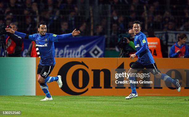 Ahmet Kulabas of Trier celebrates his team's first goal with team mate Alon Abelski during the DFB Cup second round match between Eintracht Trier and...