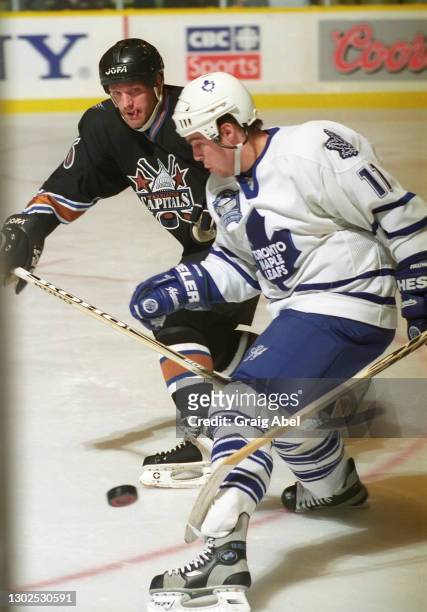 Steve Sullivan of the Toronto Maple Leafs skates against Calle Johansson of the Washington Capitals during NHL game action on January 30, 1999 at...