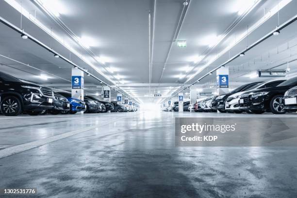 car parking lot in basement convenience shopping mall. - parking garage stock-fotos und bilder