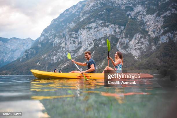 mid adult couple kayaking in triglav national park - kayak stock pictures, royalty-free photos & images