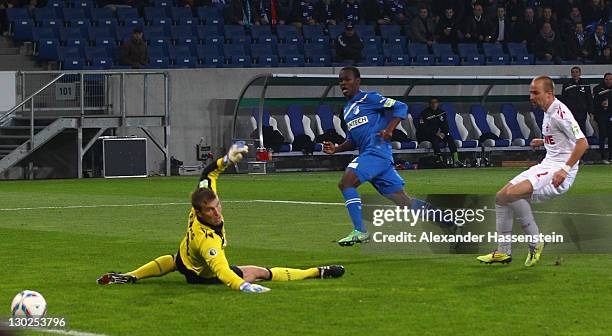 Knowledge Musona of Hoffenheim scores the second team goal against Michael Rensing, keeper of Koeln and his team mate Miso Brecko during the DFB...