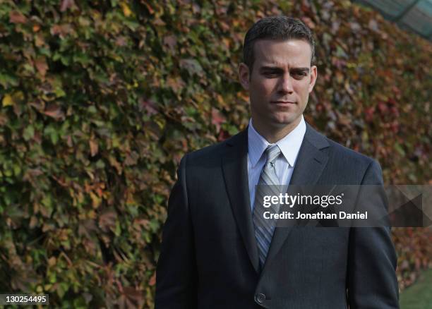 Theo Epstein, the new President of Baseball Operations for the Chicago Cubs, poses in the outfield following a press conference at Wrigley Field on...