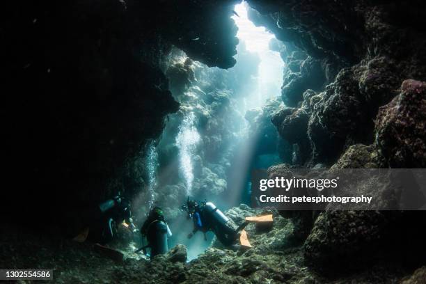 divers in a cave - underwater stock pictures, royalty-free photos & images