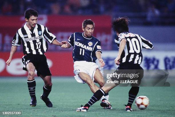 Masakiyo Maezono of Tokyo Verdy 1969 competes for the ball against Yukio Tsuchiya and Shigeyoshi Mochizuki of Vissel Kobe during the J.League J1...