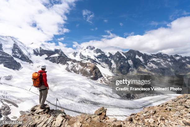 man on top of trovat peak, engadine, switzerland. - graubunden canton stock pictures, royalty-free photos & images