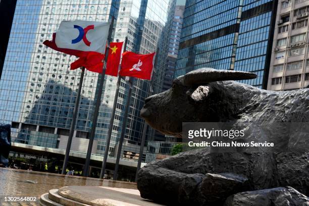 The Chinese and Hong Kong flags flutter outside the Exchange Square complex, which houses the Hong Kong Stock Exchange , on February 16, 2021 in Hong...