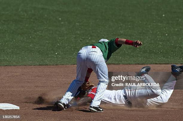 Mexican Maxwell Leon puts out Cuban Agustin Murillo on second base during their match in the XVI Panamerican Games in Lagos de Moreno, State of...