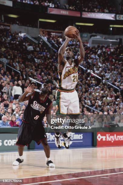 Gary Payton, Point Guard for the Seattle SuperSonics attempts a 3 point jump shot as Aaron McKie of the Philadelphia 76ers looks on during their NBA...