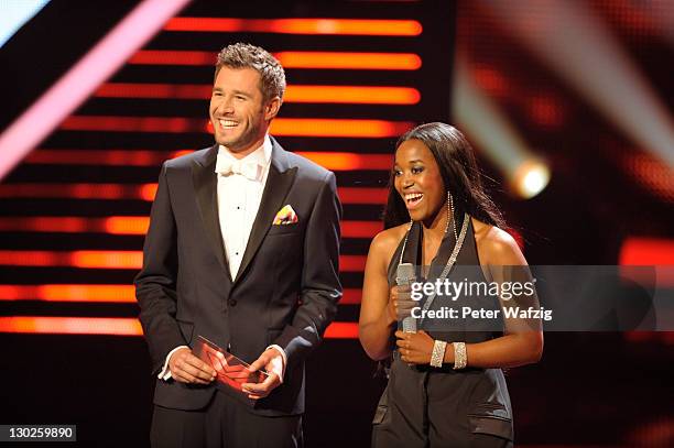 Host Jochen Schropp and Gladys Mwachiti during 'The X Factor Live' TV-Show on October 25, 2011 in Cologne, Germany.