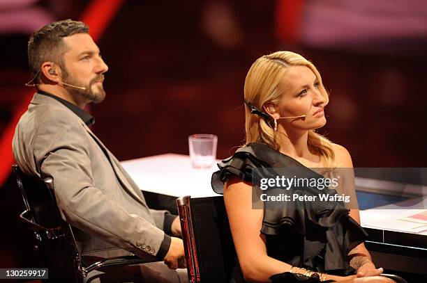 Jury members Mirko Bogojevic and Sarah Connor during 'The X Factor Live' TV-Show on October 25, 2011 in Cologne, Germany.