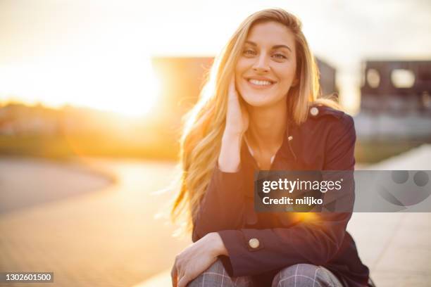 beautiful young woman at golden hour - golden hour woman stock pictures, royalty-free photos & images