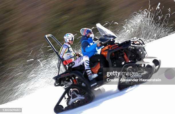 Stefan Luitz of Germany is transported back up to the start gate on a snowmobile during the FIS World Ski Championships Team's Parallel Event on...