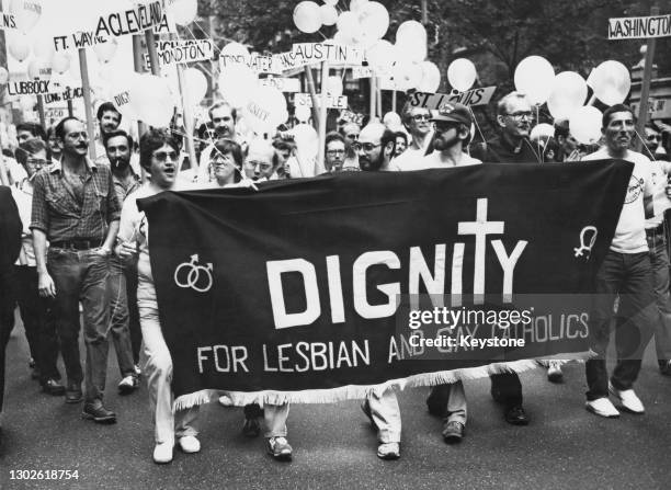 Group of lesbian and gay Catholic activists of Dignity USA holding a banner at the annual Pride Parade in a New York City, US, June 1980.