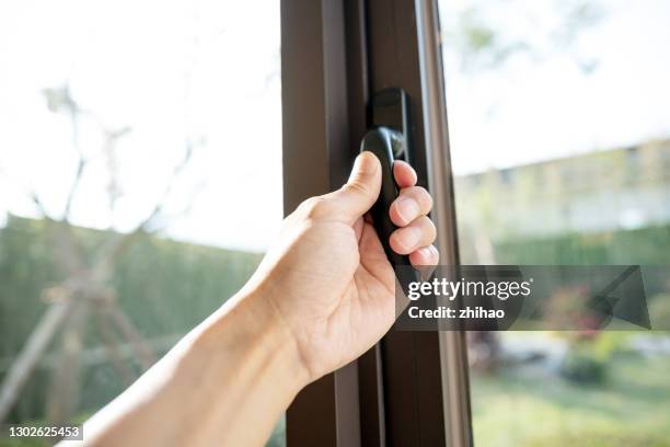 human hand ready to open the window - open window frame stock pictures, royalty-free photos & images