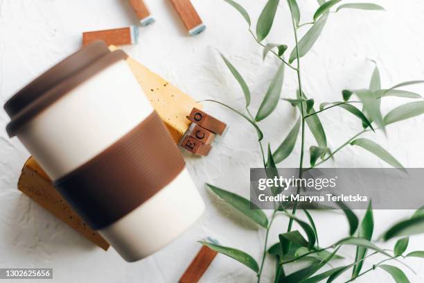 reusable ecological beverage cup in a modern composition. - branch office stock pictures, royalty-free photos & images