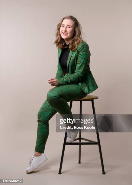 young woman on a stool - sitzen stock-fotos und bilder