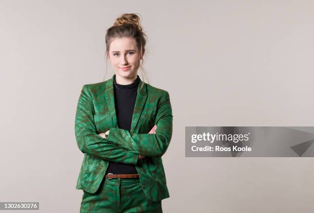 young woman in studio - green suit stock-fotos und bilder